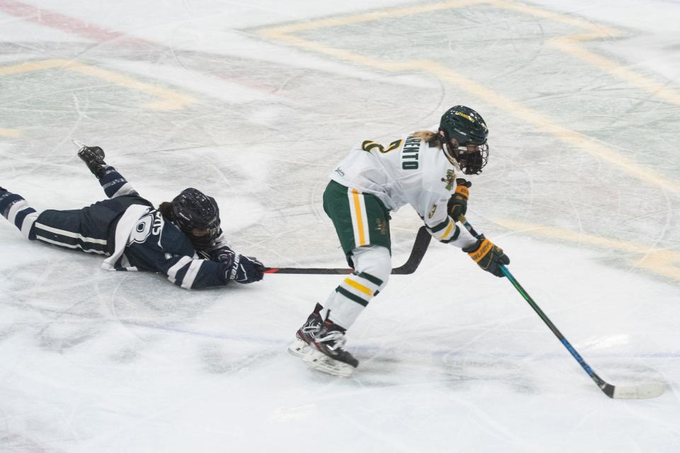 Vermont’s Bella Parento (3) skates with the puck past New Hampshire’s Tamara Thiérus (18) during the women’s hockey game between the New Hampshire Wildcats and the Vermont Catamounts at Gutterson Fieldhouse on Saturday night December 19, 2020 in Burlington, Vermont.