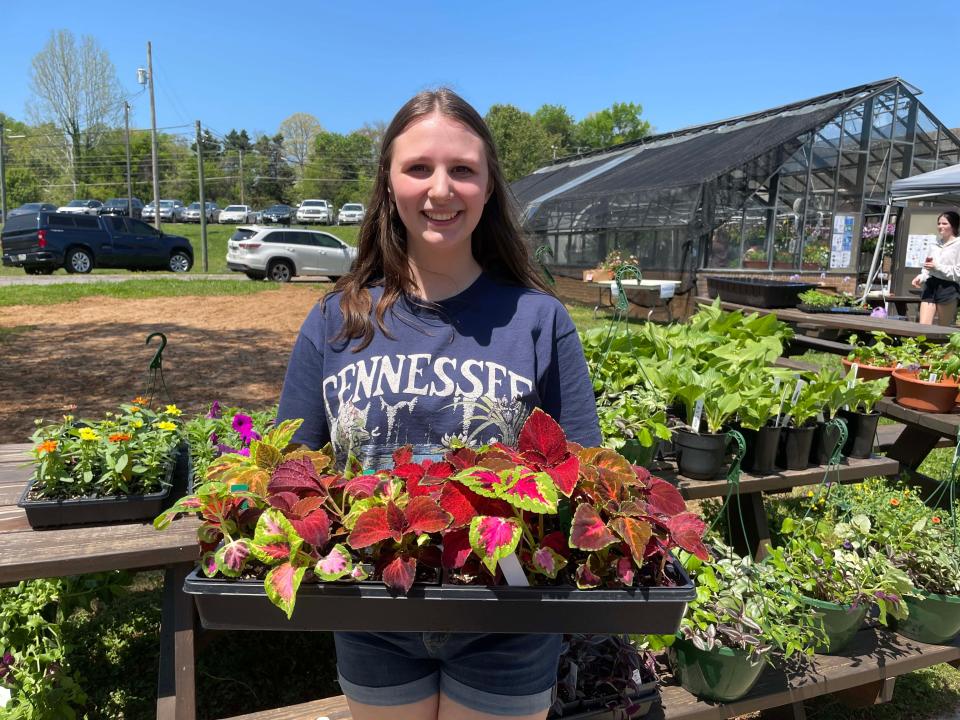 Andrea Galloway, president of the Farragut High School chapter of Future Farmers of America, offers up beautiful plants at the annual plant sale at the school April 15.