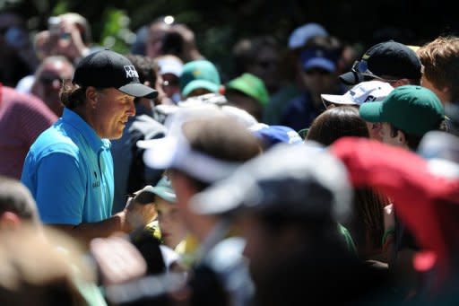 Phil Mickelson signs autographs for fans in Augusta, Georgia, on Wednesday before the 2011 Masters Tournament. An all-star cast of golf's greatest players challenge legendary Augusta National course in the 75th Masters starting on Thursday with the world number one ranking and a major title up for grabs