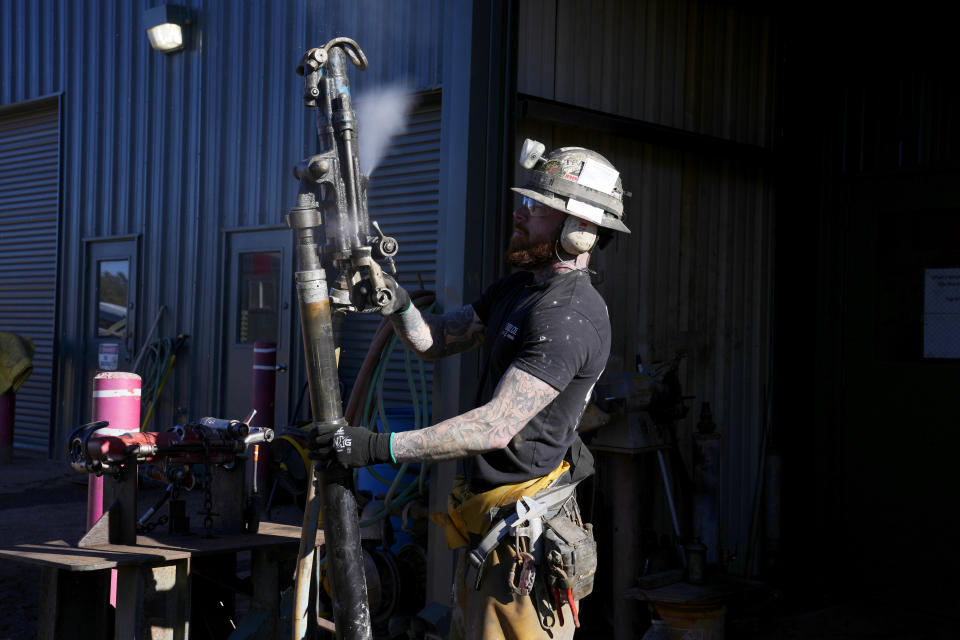 A woker checks on a piece of mining equipment at the Energy Fuels Inc. uranium Pinyon Plain Mine Wednesday, Jan. 31, 2024, near Tusayan, Ariz. The largest uranium producer in the United States is ramping up work just south of Grand Canyon National Park on a long-contested project that largely has sat dormant since the 1980s. (AP Photo/Ross D. Franklin)