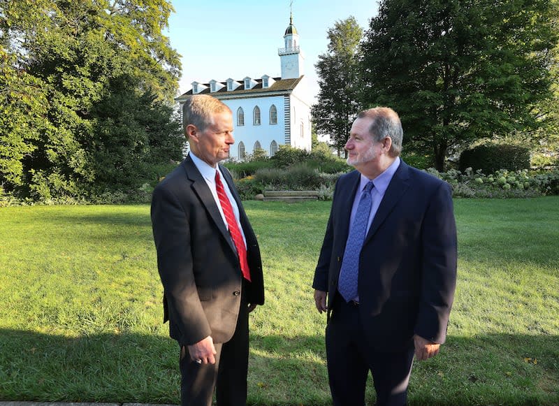 Elder David A. Bednar talks with Community of Christ Apostle Lachlan Mackay near the Kirtland Ohio Temple.