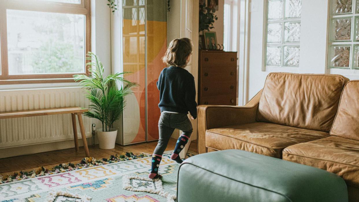 A girl running in the living room