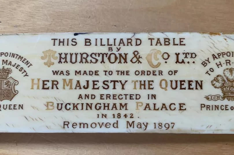 The billiards table has an ornate badge stating it was installed at Buckingham Palace in 1842 and removed in 1897