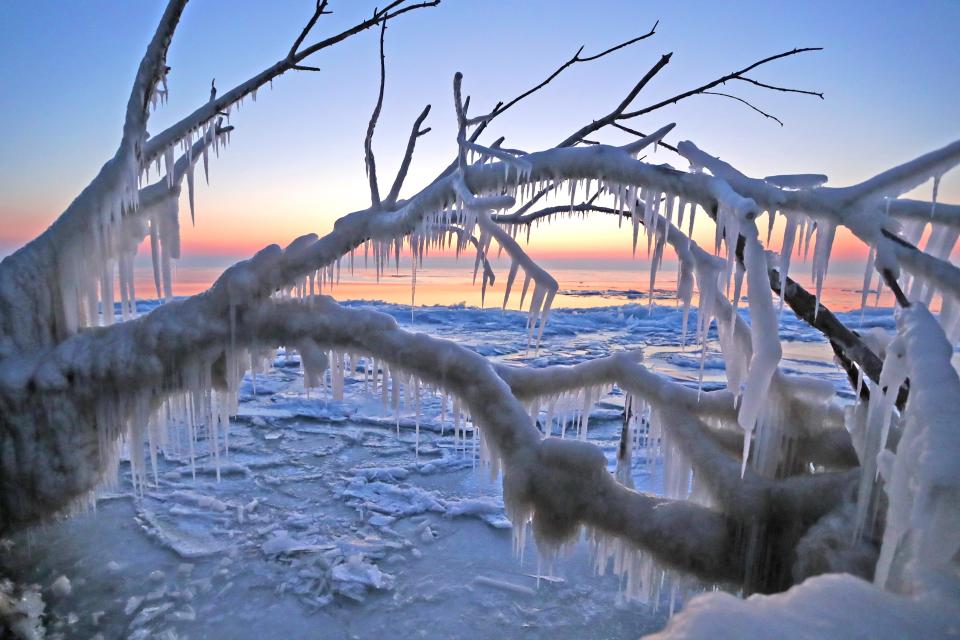 Ice formations are seen off the shore of Lake Michigan near Bradford Beach, off North Lincoln Memorial Drive in Milwaukee Saturday, Feb. 20, 2021. Due to below-zero temperatures, much of the shoreline is frozen over, leaving tree branches covered in ice.