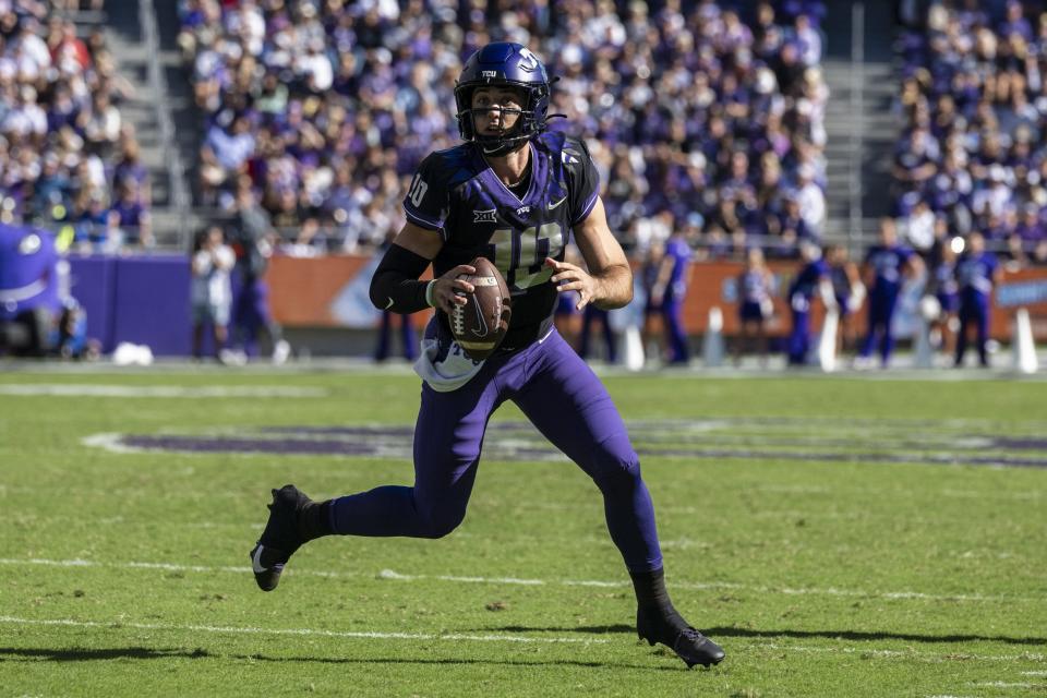 TCU Horned Frogs quarterback Josh Hoover rolls out to pass against the Brigham Young Cougars during the game at Amon G. Carter Stadium.