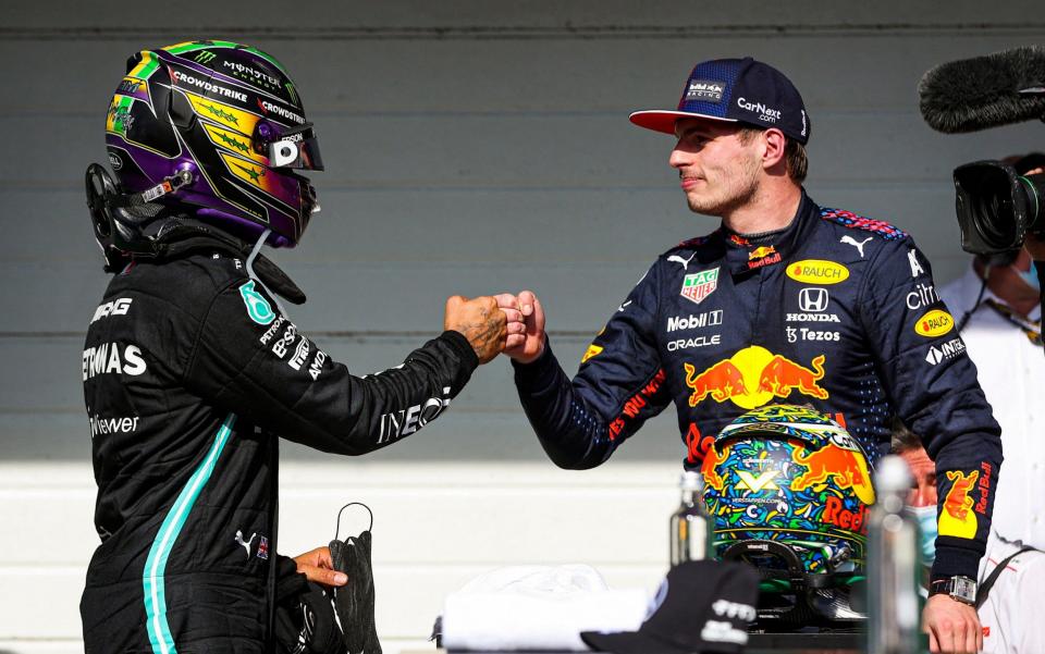 Mercedes' British driver Lewis Hamilton (L) and Red Bull's Dutch driver Max Verstappen (R) greet eachother after obtaining the first and second positions respectively, in Brazil's Formula One Sao Paulo Grand Prix at the Autodromo Jose Carlos Pace, or Interlagos racetrack, in Sao Paulo, on November 14, 2021 - AFP