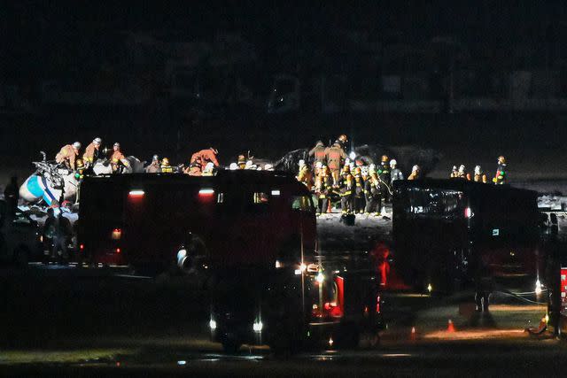 <p>RICHARD A. BROOKS/AFP via Getty </p> Rescue crews work at the site where a Japan coast guard aircraft collided with a Japan Airlines (JAL) passenger plane on the tarmac at Tokyo International Airport at Haneda on January 2, 2024.