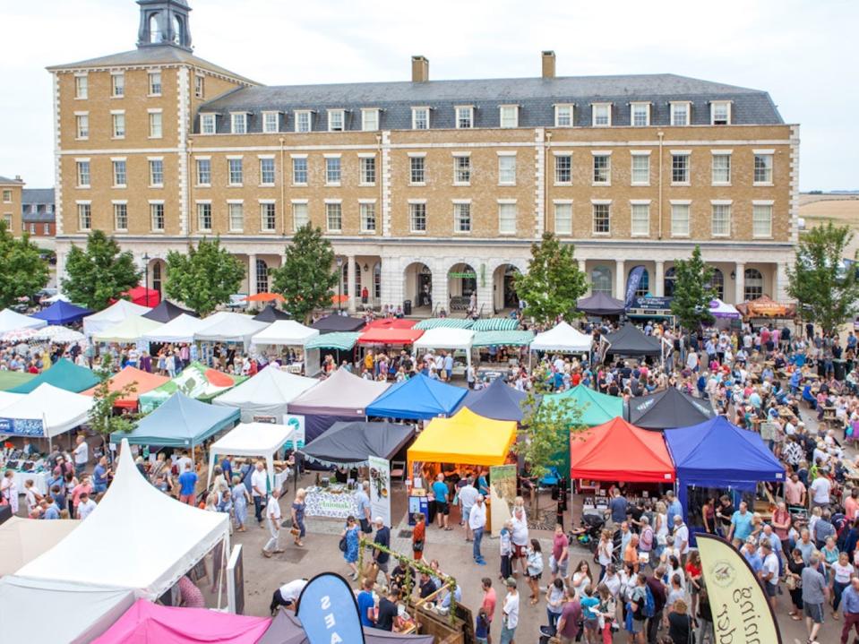 Residents of Poundbury, Dorset attend a local market.