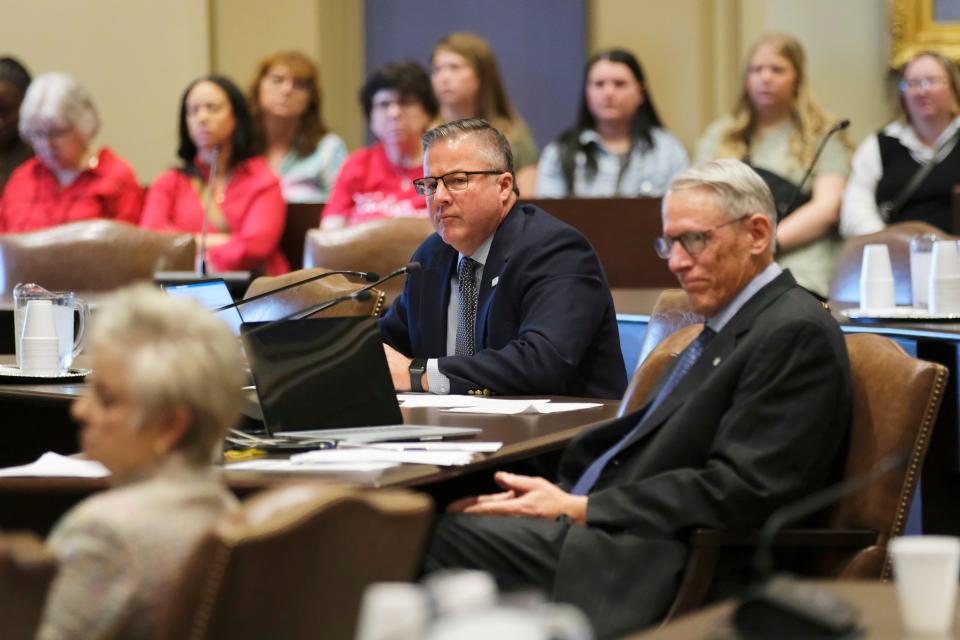 Sen. Lonnie Paxton, middle, and Sens. Julie Daniels and Dave Radar listen to a response Tuesday at a Senate Education Committee meeting.