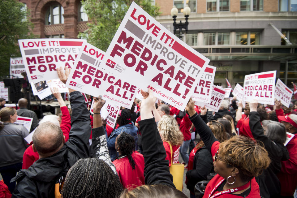 UNITED STATES - APRIL 29: Members of National Nurses United union members wave "Medicare for All" signs during  a rally in front of the Pharmaceutical Research and Manufacturers of America in Washington calling for "Medicare for All" on Monday, April 29, 2019.  (Photo By Bill Clark/CQ Roll Call)