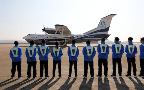 Ground staff stand guard - Credit: REUTERS