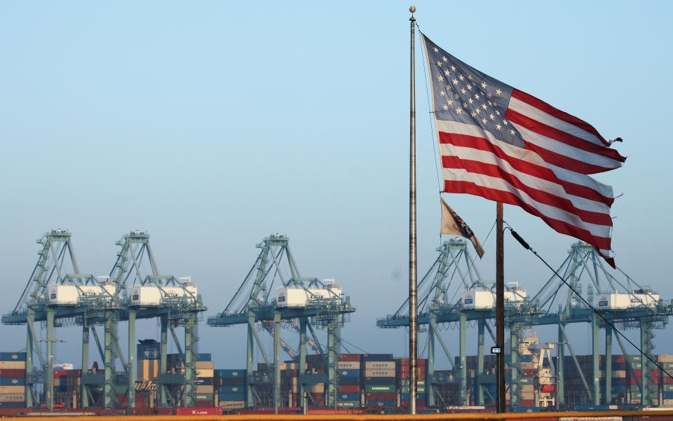 SAN PEDRO, CALIFORNIA - NOVEMBER 07: An American flag flies nearby with shipping containers stacked at the Port of Los Angeles in the background, which is the nation's busiest container port, on November 7, 2019 in San Pedro, California. Port officials said today October cargo volume was down 19 percent this year compared with October 2018 due to tariffs imposed in the U.S.-China trade war. The Port of Los Angeles along with neighboring Port of Long Beach are the United States' main gateways for trade with Asia. (Photo by Mario Tama/Getty Images)