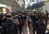 Supporters queue up outside a court to try to get in for a hearing in Hong Kong Monday, March 1, 2021. Pro-democracy activists detained by police on Sunday on charges of conspiracy to commit subversion under the sweeping national security law, are expected to appear in court. (AP Photo/Vincent Yu)