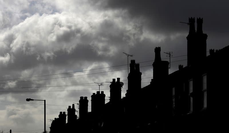 Rain clouds gather behind a row of terraced houses in Altrincham, northern England