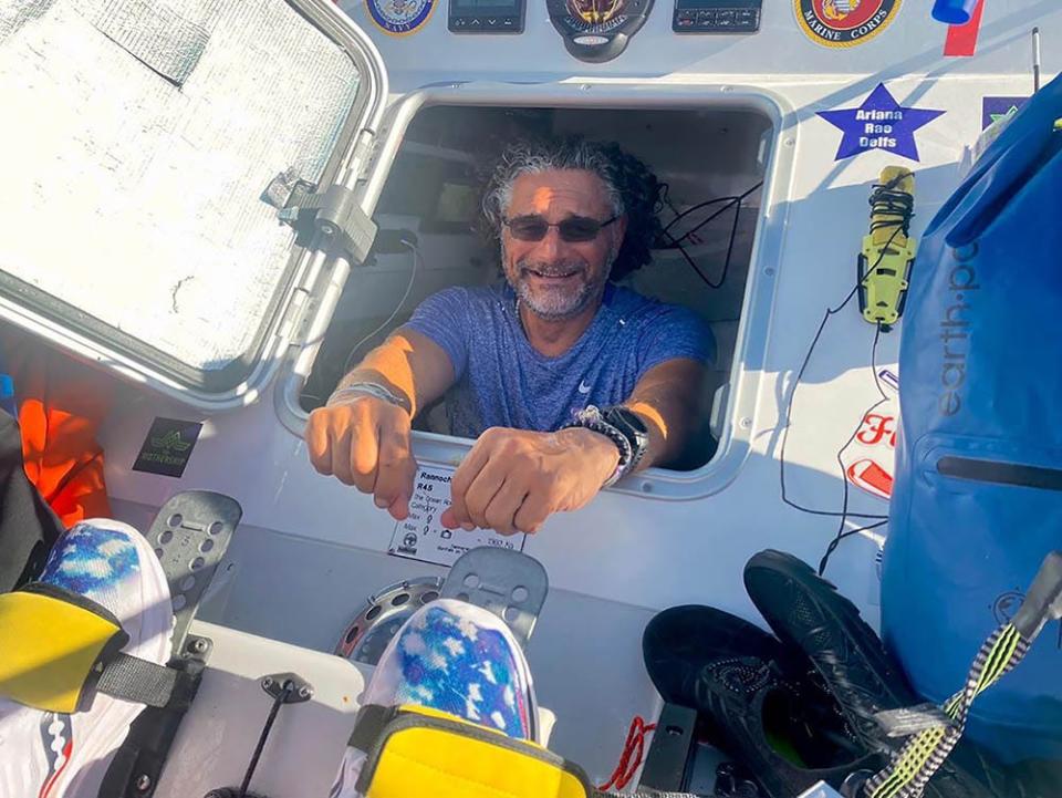 Paul Lore peers out from one of two sleeping cabins on his Foar From Home rowing team's boat. The four-man Fernandina Beach-based group is taking part in a 3,000-mile charity row across the Atlantic.