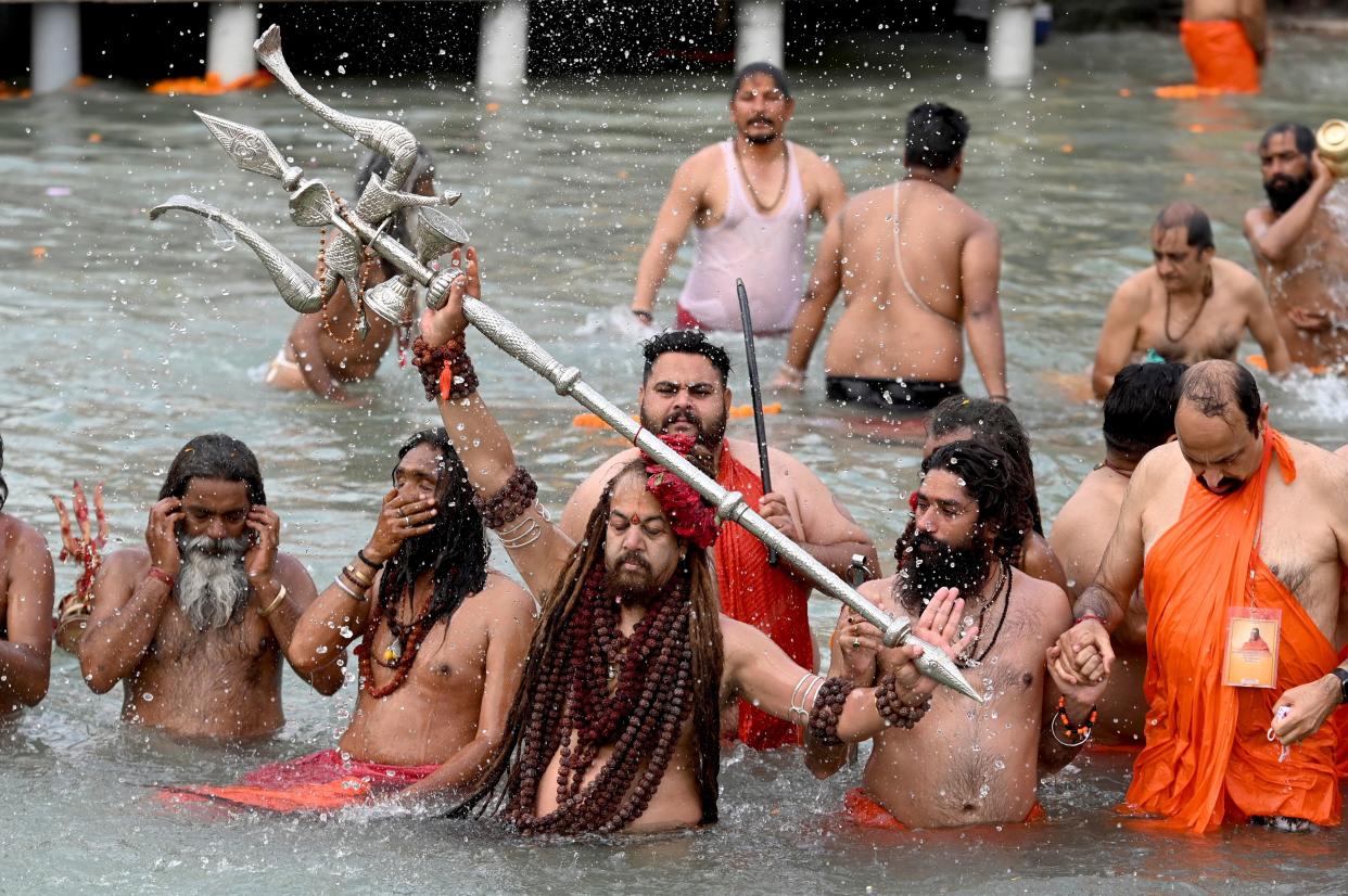 Sadhus (Hindu holy men) take a holy dip in the waters of the Ganges River on the day of Shahi Snan (royal bath) during the ongoing religious Kumbh Mela festival, in Haridwar on April 12, 2021. (Photo by Money SHARMA / AFP) (Photo by MONEY SHARMA/AFP via Getty Images)