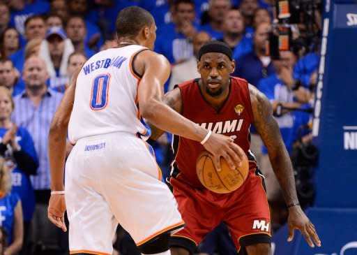 Miami Heat's LeBron James (R) defends as Oklahoma City Thunder's Russell Westbrook drives towards the basket during their game on June 12. James had a team-high 30 points