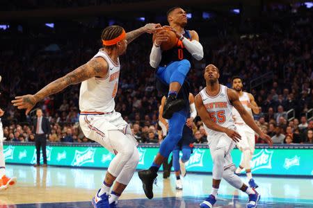 Dec 16, 2017; New York, NY, USA; Oklahoma City Thunder point guard Russell Westbrook (0) drives to the basket against New York Knicks small forward Michael Beasley (8) and point guard Jarrett Jack (55) during the first quarter at Madison Square Garden. Mandatory Credit: Brad Penner-USA TODAY Sports