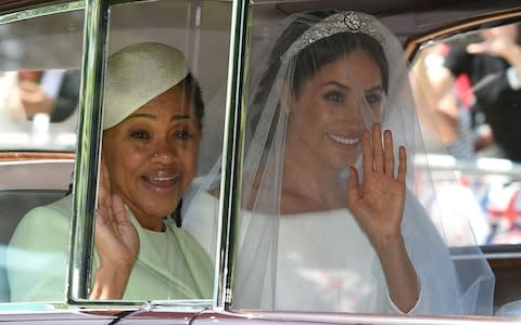 Meghan Markle and her mother Doria Ragland travel to St George's Chapel - Credit: AFP