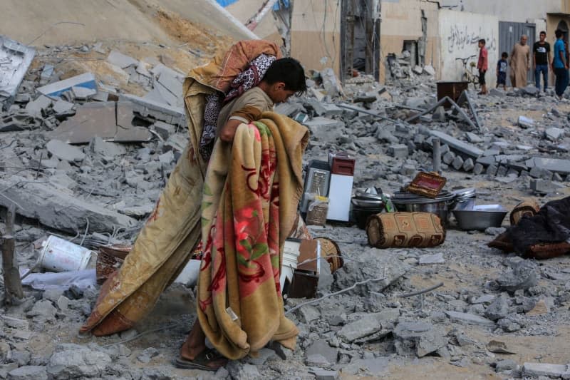 A Palestinian inspects a damaged house after Israeli warplanes bombed a home for the Al-Shaer family, leading to widespread destruction in the Al-Salam neighbourhood, east of the city of Rafah, in the southern Gaza Strip. Abed Rahim Khatib/dpa