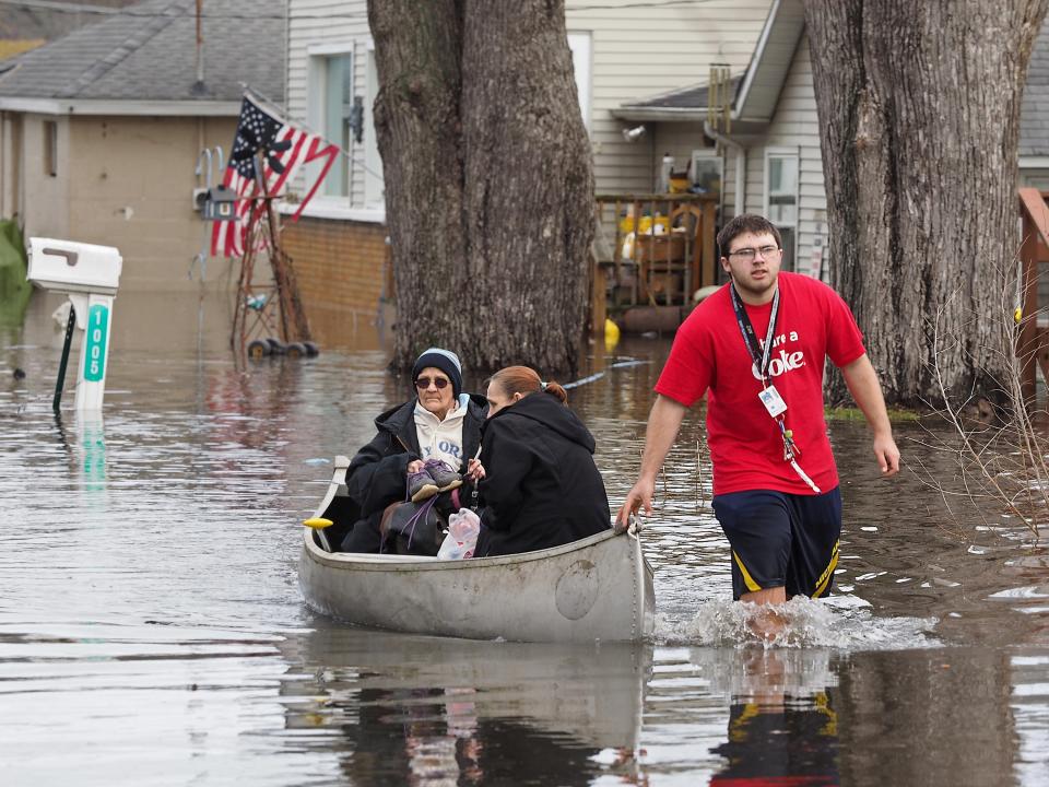 <p>Garry Clark, 15, uses a canoe to take his grandmother Jeanne Kendall and June Wedl from their flooded home Thursday, Feb. 22, 2018 in Comstock’s Lakewood neighborhood. Severe and record-breaking flooding is predicted for the Kalamazoo River at Comstock, the National Weather Service Grand Rapids said Thursday. (Photo: Mark Bugnaski/Kalamazoo Gazette-MLive Media Group via AP) </p>