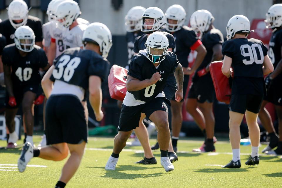 Bearcats linebacker Ivan Pace Jr. (0) runs through a drill during the first day of preseason training camp at the University of Cincinnati’s Sheakley Athletic Complex in Cincinnati on Wednesday, Aug. 3, 2022.