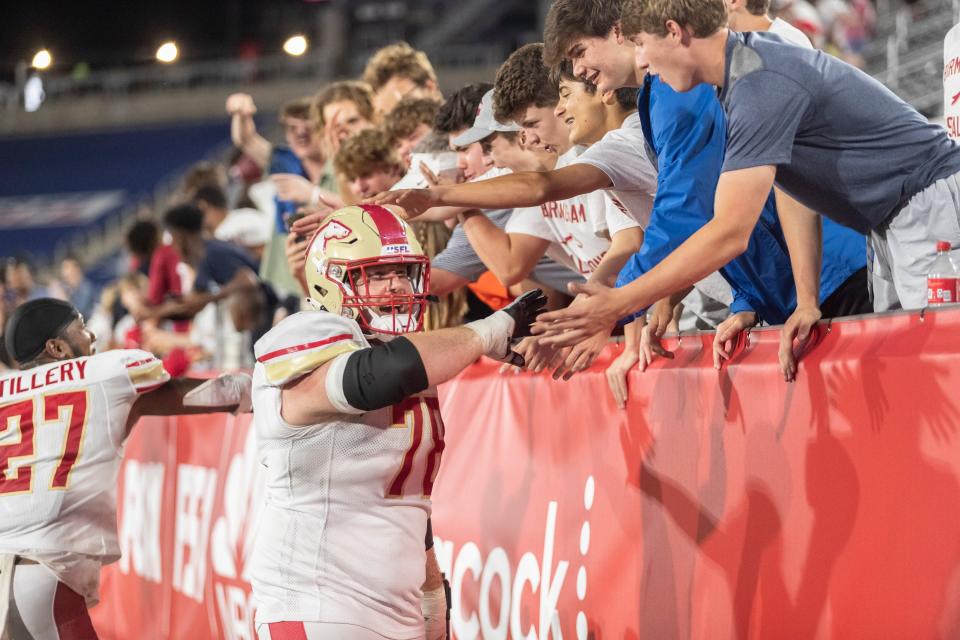 Birmingham Stallions offensive lineman Cameron Hunt celebrates a win over the New Orleans Breakers with the fans at Protective Stadium.