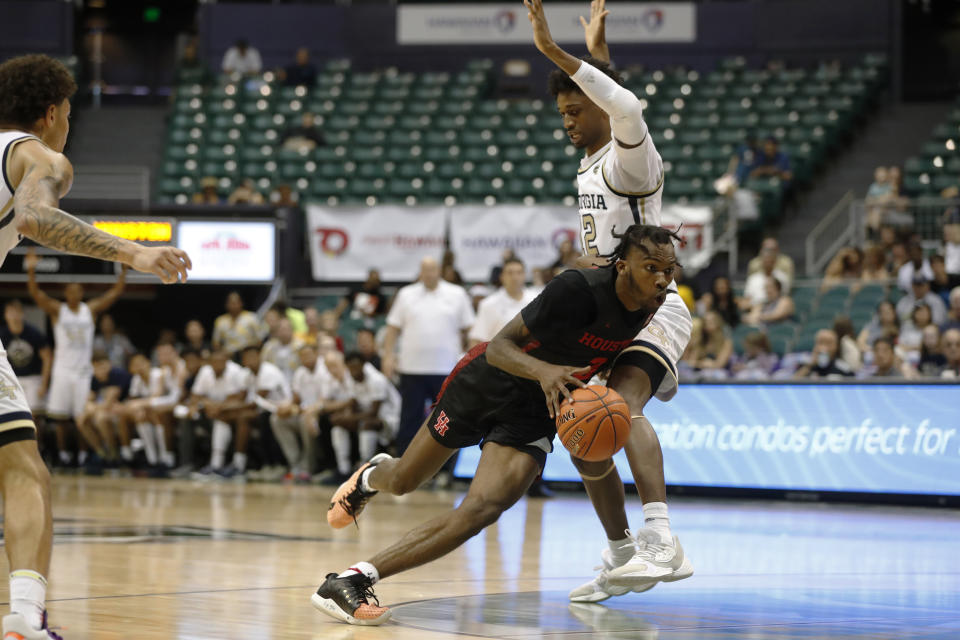 Houston guard DeJon Jarreau (3) dribbles past Georgia Tech forward Khalid Moore (12) during the second half of an NCAA college basketball game Monday, Dec. 23, 2019, in Honolulu. (AP Photo/Marco Garcia)