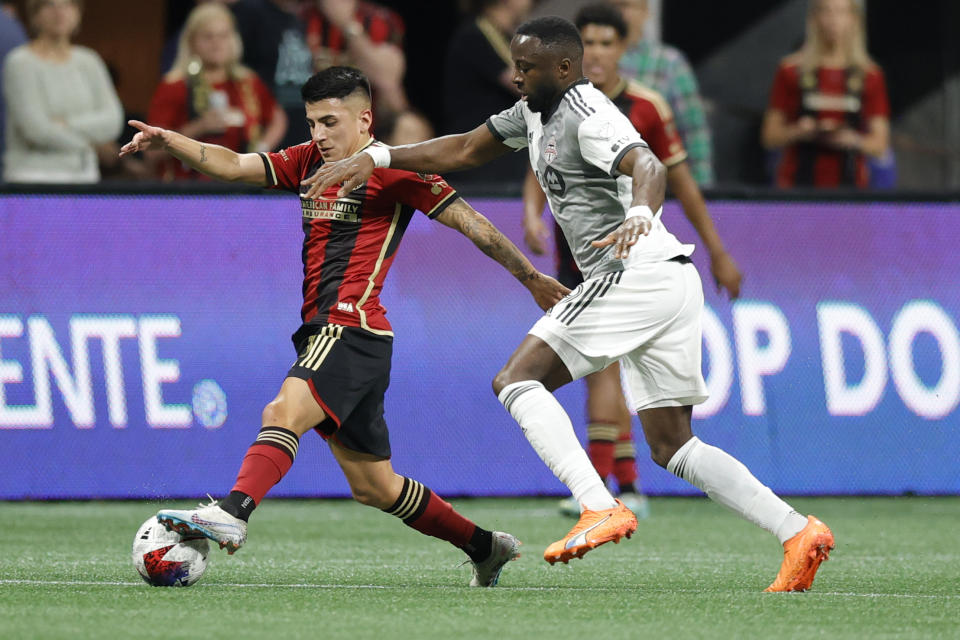 Atlanta United midfielder Thiago Almada, left, drives the ball past Toronto FC forward Adama Diomande, right, during the first half of an MLS soccer match, Saturday, March 4, 2023, in Atlanta. (AP Photo/Alex Slitz)