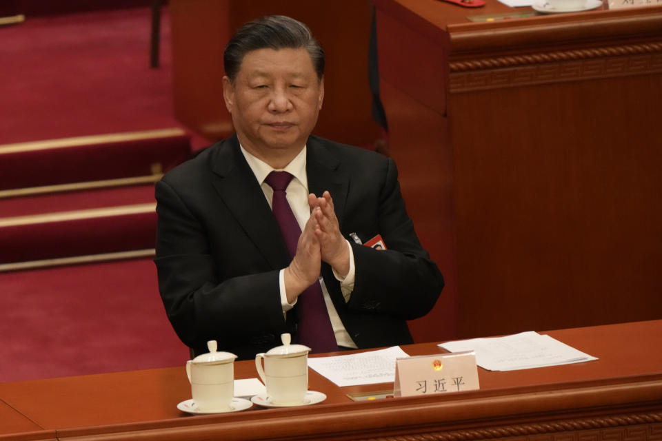 Chinese President Xi Jinping applauds during a session of China's National People's Congress (NPC) at the Great Hall of the People in Beijing, Friday, March 10, 2023. (AP Photo/Mark Schiefelbein)