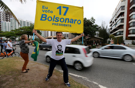 A supporter of presidential candidate Jair Bolsonaro is seen in front of Bolsonaro's condominium at Barra da Tijuca neighborhood in Rio de Janeiro, Brazil October 4, 2018. REUTERS/Sergio Moraes