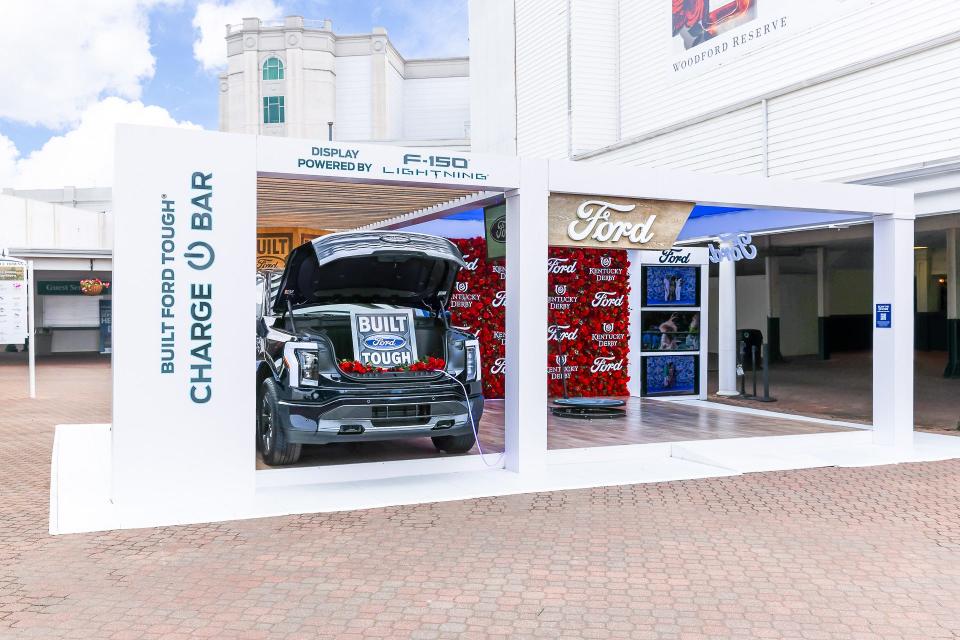 Ford Motor Co. and Churchill Downs Racetrack have a multi-year partnership deal. One aspect of this partnership is Ford's display featuring a flower wall, F-150 Lighting and a phone charging station, in the Paddock Plaza during the Kentucky Oaks and Derby.