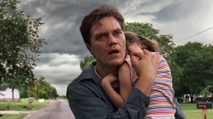 Michael Shannon carries a child in Take Shelter.