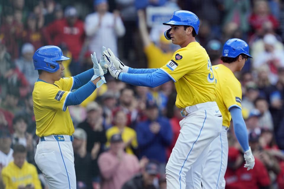 Boston Red Sox's Triston Casas, right, celebrates after his two-run home run that also drove in Masataka Yoshida, left, during the first inning of a baseball game against the Los Angeles Angels, Saturday, April 13, 2024, in Boston. (AP Photo/Michael Dwyer)