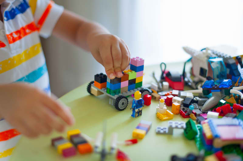 kid in shirt playing with legos