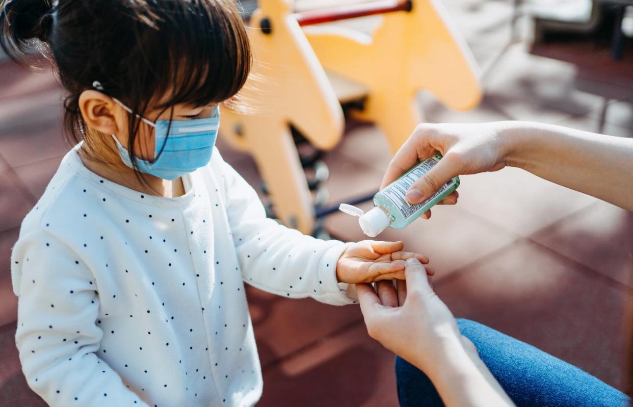 <span class="caption">Wearing a mask and using hand sanitizers can protect you and your family at this critical time. </span> <span class="attribution"><a class="link " href="https://www.gettyimages.com/detail/photo/young-mother-squeezing-hand-sanitizer-onto-little-royalty-free-image/1208508344?adppopup=true" rel="nofollow noopener" target="_blank" data-ylk="slk:d3sign/Getty Images;elm:context_link;itc:0;sec:content-canvas">d3sign/Getty Images</a></span>