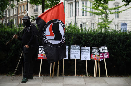 A demonstrator holds a flag during an anti-fascist protest outside the U.S Embassy in London, Britain, August 14, 2017. REUTERS/Hannah McKay