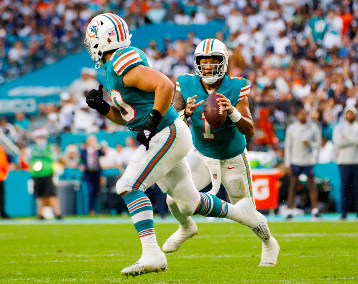 Miami Dolphins quarterback Tua Tagovailoa (1) looks to pass to teammate Dolphins fullback Alec Ingold (30) during first quarter of an NFL football game against the Dallas Cowboys at Hard Rock Stadium on Sunday, Dec. 24, 2023 in Miami Gardens, Fl.