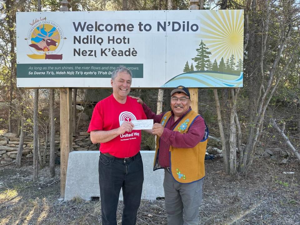 David Connelly, chair of the United Way NWT’s emergency response committee, presents rapid response funding to Yellowknives Dene Chief Fred Sangris, to support Yellowknives Dene members evacuated from the South Slave region due to fires. (United Way NWT - image credit)