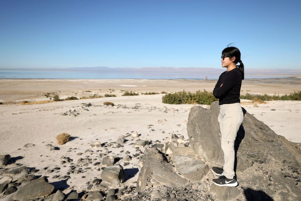 Caroline Hung, a doctoral candidate in the University of California, Riverside’s Department of Earth and Planetary Sciences Lyons Biogeochemistry Lab, stands on Obsidian Butte looking over the Salton Sea, in Imperial County, Calif., on Tuesday, Dec. 12, 2023. | Kristin Murphy, Deseret News