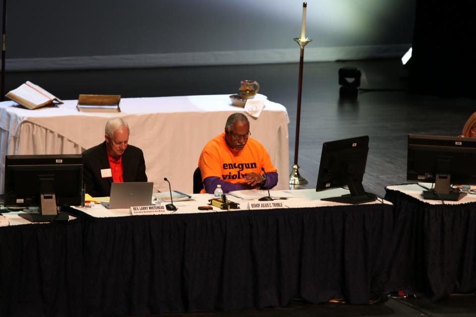 Rev. Larry Whitehead, executive assistant to the bishop, left, and Bishop Julius C. Trimble oversee a plenary session of the annual conference of the United Methodist Churches of Indiana. The event was conducted at Ball State University. Trimble heads the state organization and sported an orange shirt at the session Friday pleading for an end to gun violence. The conference saw 174 Hoosier congregations disaffiliate from the UMC in a split between traditionalists and progressives in the church.