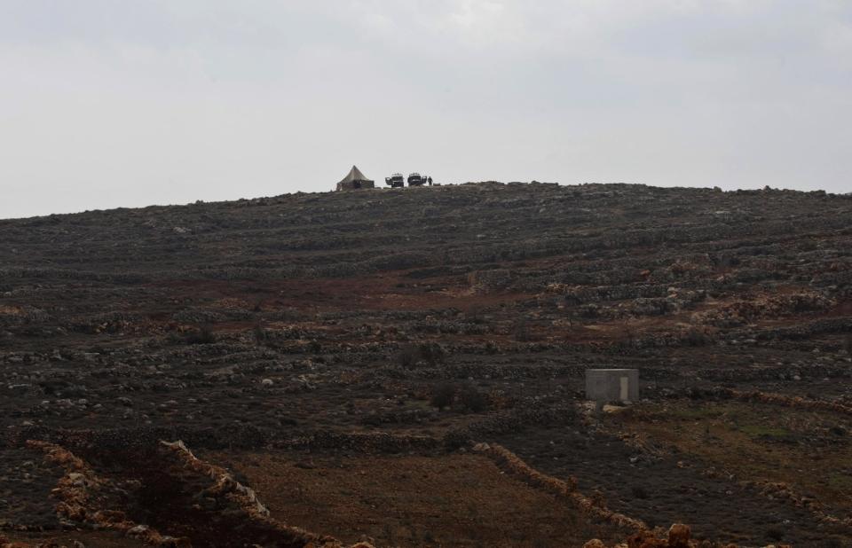 The Israeli military places a tent near the West Bank village of Qusra, southeast of Nablus, Tuesday, Jan. 14, 2014. The annual rate of Israeli settler attacks against Palestinians has almost quadrupled in eight years, U.N. figures show, buttressing claims that Israeli security forces have largely failed to stem the so-called "price tag" campaign in which thugs cut down trees, deface mosques and beat Palestinian farmers. (AP Photo/Nasser Ishtayeh)