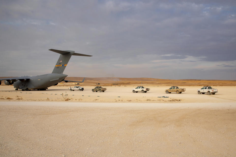 In this Oct. 25, 2019, photo, released by the U.S. Army Reserve, pickup trucks are vehicles lined up to be loaded onto a cargo plane as part of the deliberate withdrawal of coalition forces from northern Syria at the Kobani Landing Zone (KLZ). Pivoting from the dramatic killing of the Islamic State group's leader, the Pentagon is increasing U.S. efforts to protect Syria's oil fields from the extremist group as well as from Syria itself and the country's Russian allies. It's a new high-stakes mission even as American troops are withdrawn from other parts of the country.(U.S. Army Reserve photo by Staff Sgt. Joshua Hammock via AP)