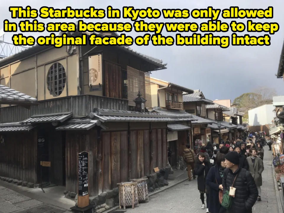 A bustling street scene with traditional wooden buildings and pedestrians walking