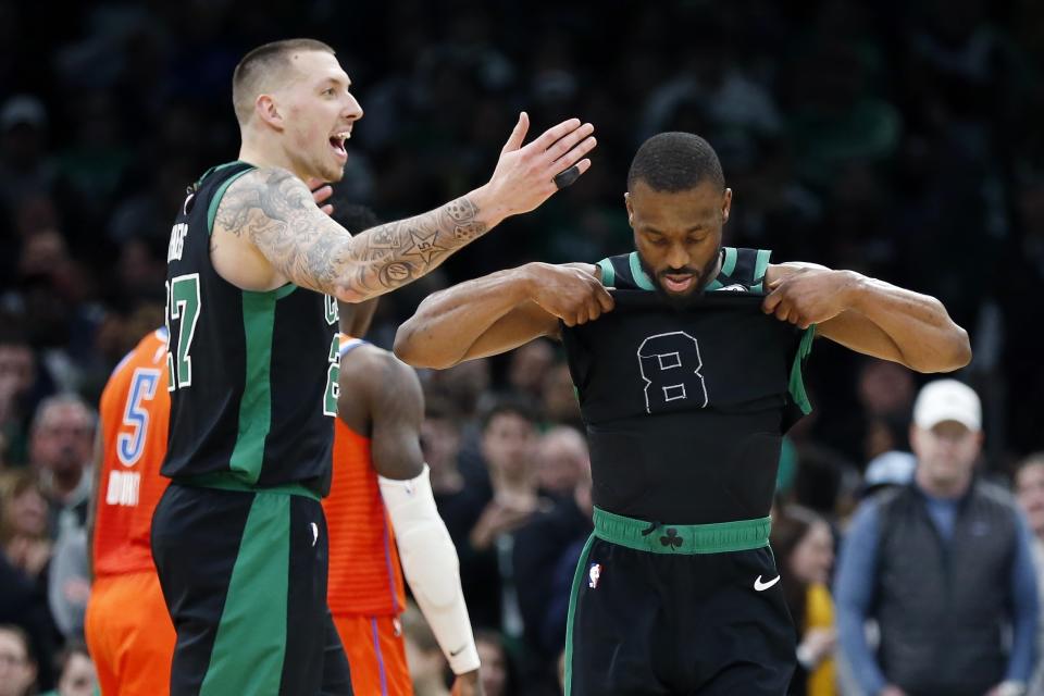 Boston Celtics' Daniel Theis (27) and Kemba Walker (8) react after losing to the Oklahoma City Thunder during an NBA basketball game, Sunday, March, 8, 2020, in Boston. (AP Photo/Michael Dwyer)