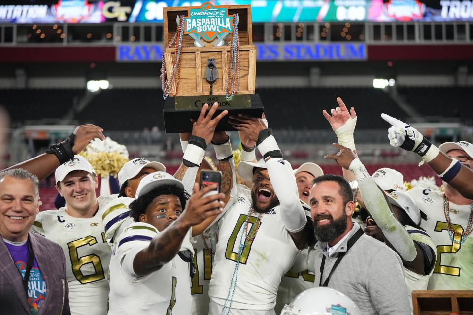 Gasparilla Bowl: The Georgia Tech Yellow Jackets celebrate with the trophy after defeating the Central Florida Knights at Raymond James Stadium in Tampa on Dec. 22, 2023.
