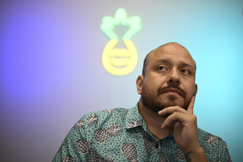 Andres Acosta Ardila, director of community relations at Pineapple Healthcare, sits in the medical clinic in Orlando, Fla., on May 28, 2024. (AP Photo/Phelan M. Ebenhack)