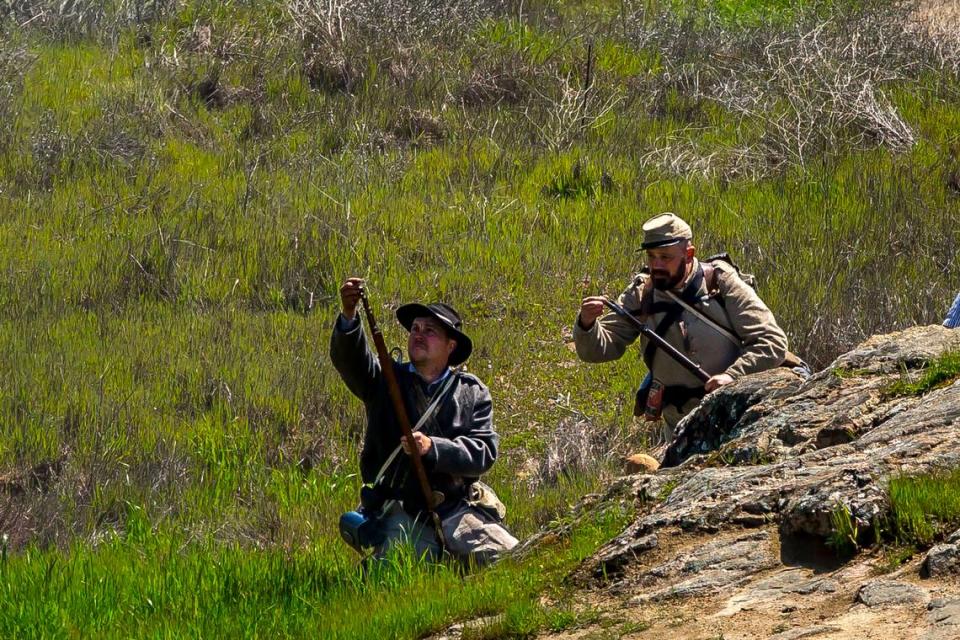 Unidentified men role-playing Confederate snipers reload during a Civil War reenactment in Knights Ferry, Calif. the weekend of March 25 and 26, 2023. Richard B. Raef/Working Ranch Photography