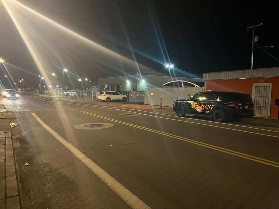 A fence is up and sheriff's deputies are parked around the Maricopa County Recorder's Office in Phoenix on the evening of Aug. 2, 2022, as primary election results are released.