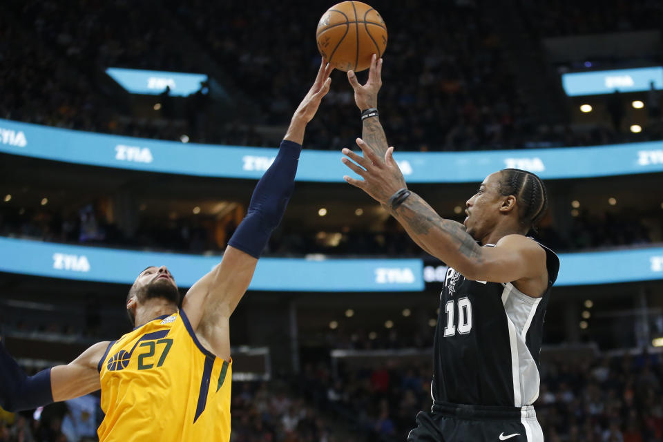 Utah Jazz center Rudy Gobert (27) blocks the shot of San Antonio Spurs forward DeMar DeRozan (10) during the first half of an NBA basketball game Friday, Feb. 21, 2020, in Salt Lake City. (AP Photo/Rick Bowmer)